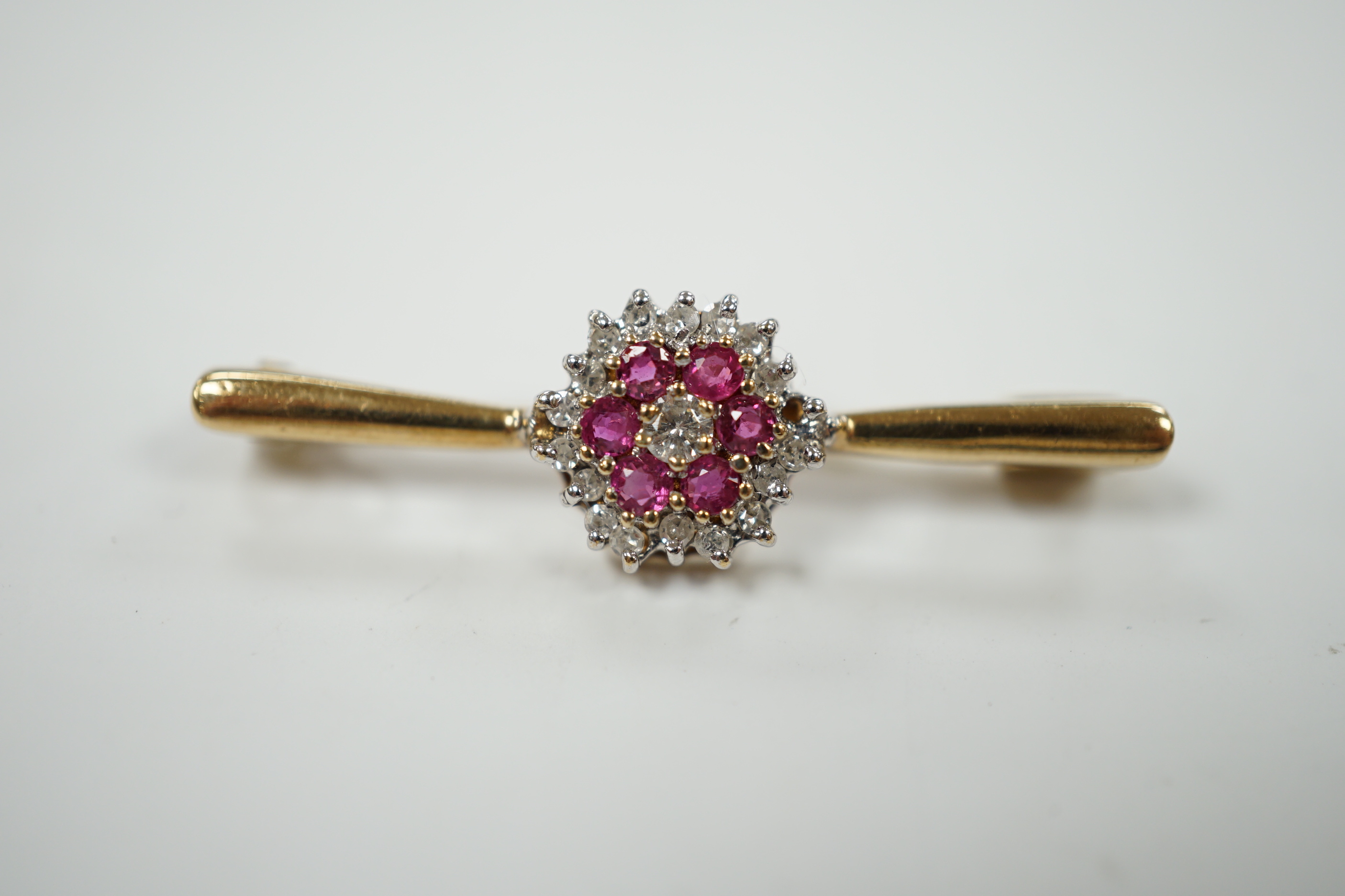 A 9ct, ruby and diamond cluster set bar brooch, 35mm, gross weight 2.7 grams.